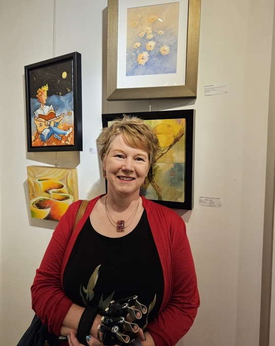 Sandra Woods beside one of her paintings at the Viva Vida Gallery, 15 Nov 2024